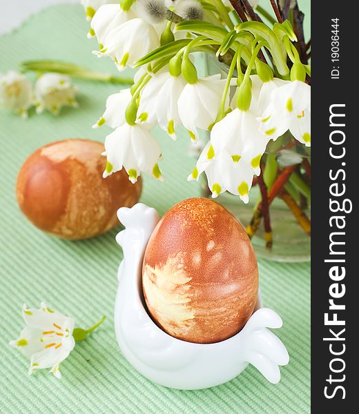 Easter Eggs in chicken shaped eggcup with flower