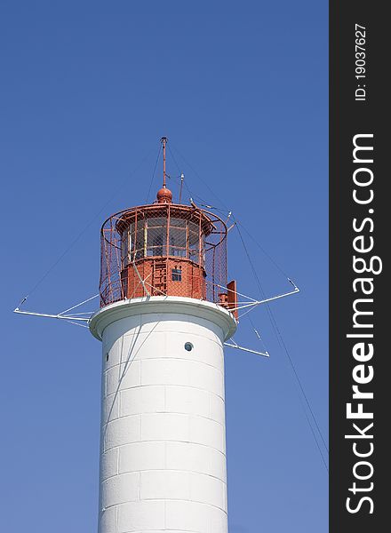 White lighthouse on a background blue sky