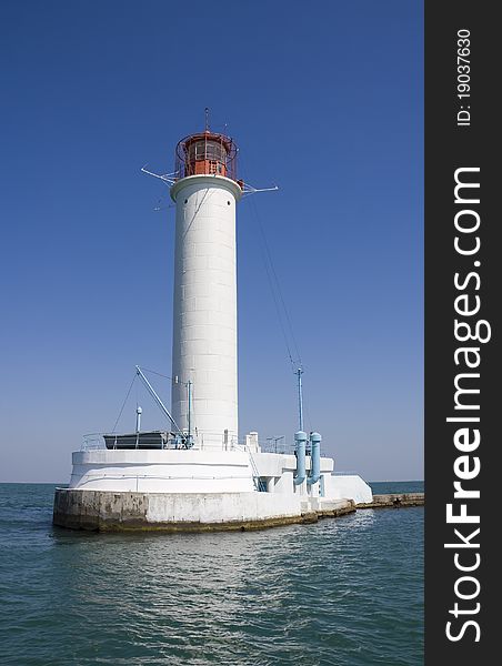 White lighthouse on a background blue sky