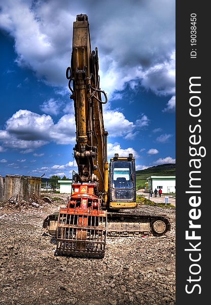 A demolition heavy machine in a construction site of a water treatment plant, at the end of the day. A demolition heavy machine in a construction site of a water treatment plant, at the end of the day.