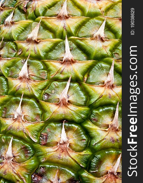 Textured surface of pineapple as a background