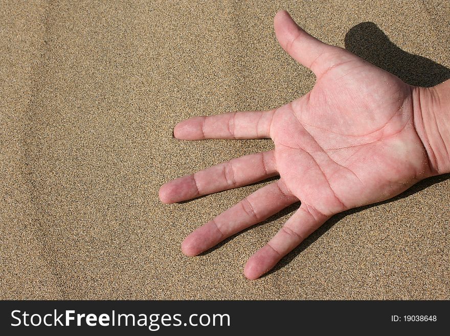 Hand in the Sand of a young Man