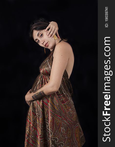 Portrait of pregnant hispanic beauty on dress isolated on black. Portrait of pregnant hispanic beauty on dress isolated on black