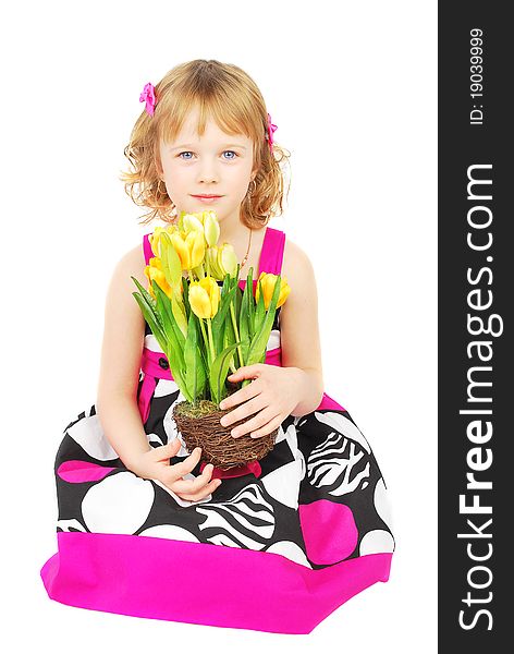 Pretty little girl wearing a pink  and black sumer dress smiling  with spring yellow flowers   isolated on white background. Pretty little girl wearing a pink  and black sumer dress smiling  with spring yellow flowers   isolated on white background.