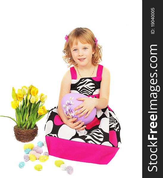Portrait of a happy little girl with big easter egg, flowers on the white background.