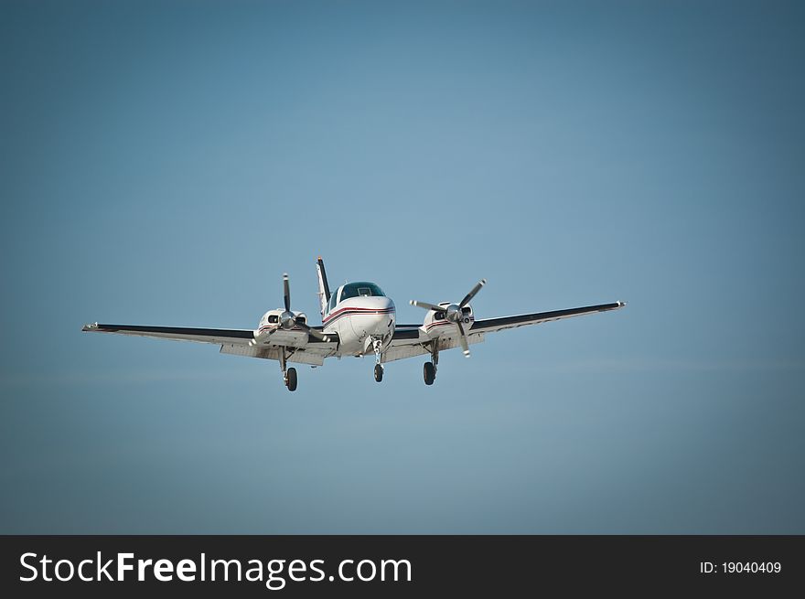 A twin engine light aircraft makes an approach for landing. A twin engine light aircraft makes an approach for landing.