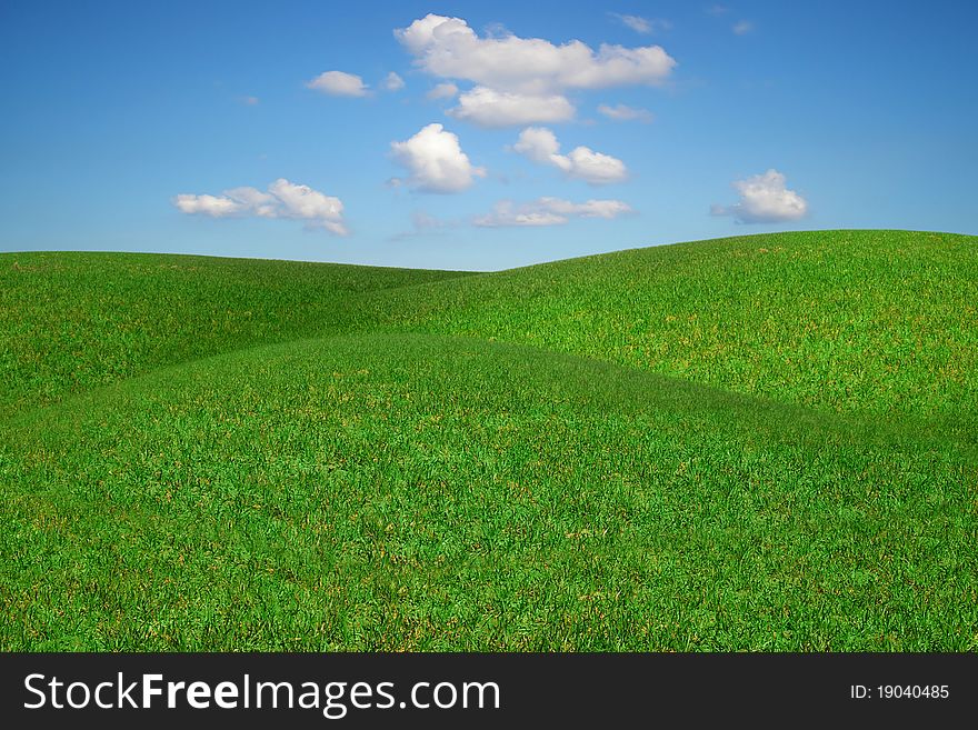 Picturesque landscape with green field and blue sky. Picturesque landscape with green field and blue sky