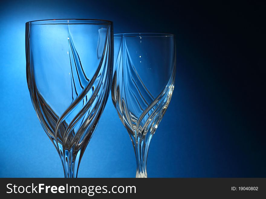Drinking glasses on blue background with selective coloring