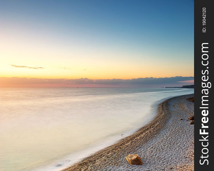 Beautiful seascape. Sea and rock at the sunset. Nature composition.