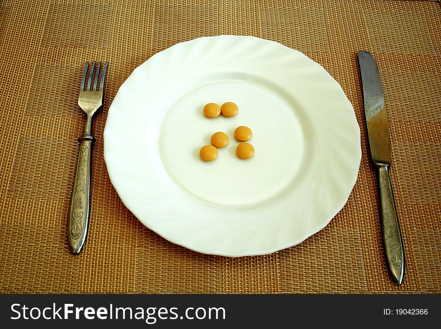 Pills on the white plate for dinner