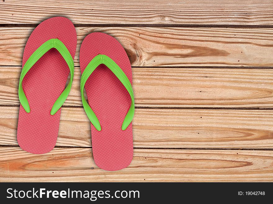 Red Ang Green Flip Flop Sandals On Wood