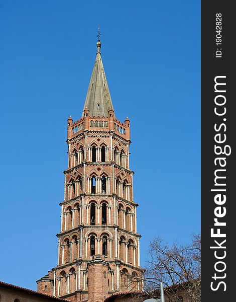 Top of St. Sernin church in a blue sky day