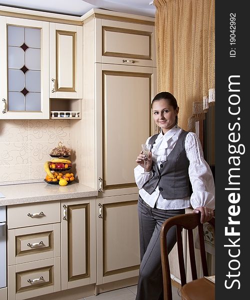 Young woman to kitchen in classical style