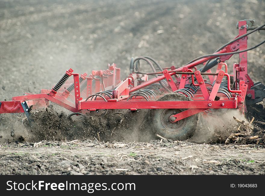 Preparing the soil in the field harrows