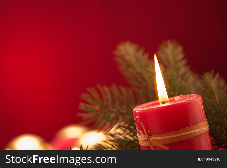 Lighting Christmas red candle with red background. Lighting Christmas red candle with red background