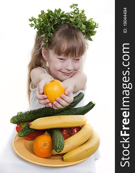 Child Holds Vegetables And Fruit.