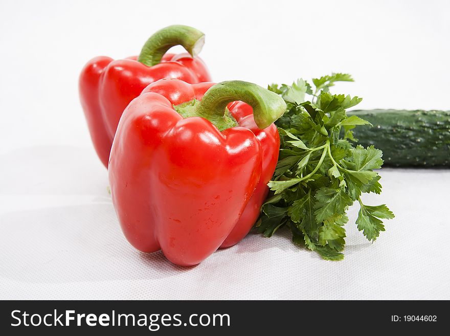 Vegetables - red pepper, parsley, cucumber on a white background