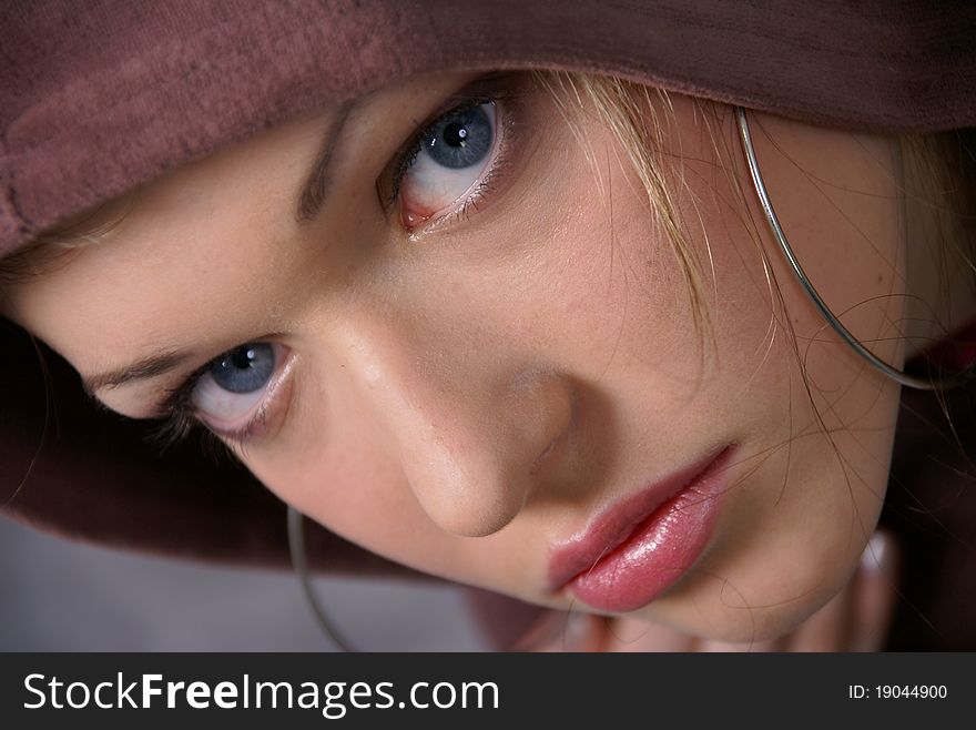 Portrait of a young woman in a robe with a hood. Portrait of a young woman in a robe with a hood