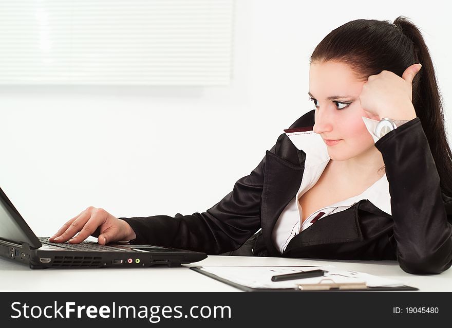 Woman in a business suit working in the office. Woman in a business suit working in the office