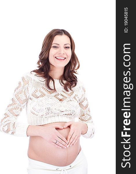 Smiling pregnant woman show heart sign on her belly