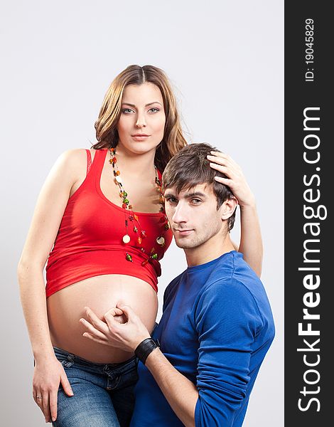 Man show ok sign on pregnant belly of his wife