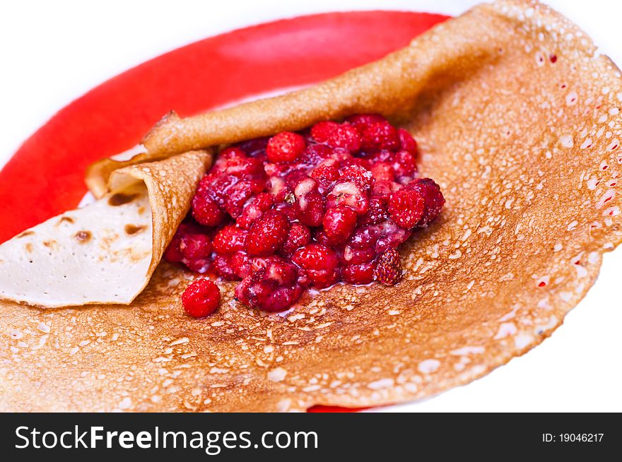 Fresh berries wrapped in a pancake isolated on white