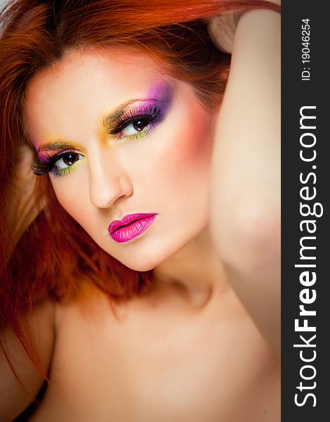 Sexy woman with multicolored make-up