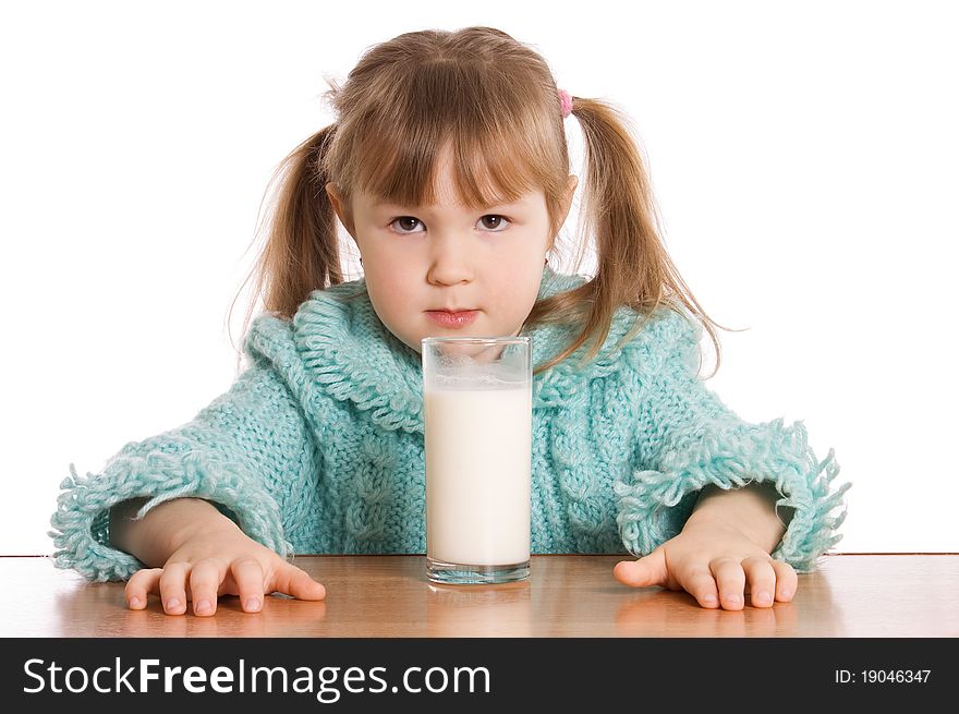 The little girl with a milk glass on white