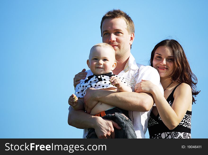 Happy family on blue sky background. Happy family on blue sky background