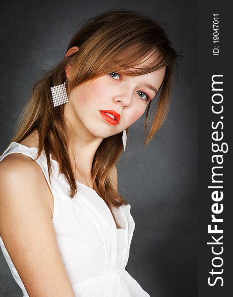 Girl in white blouse with a gray background