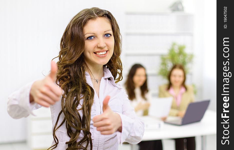 The beautiful business woman with a team on a back background