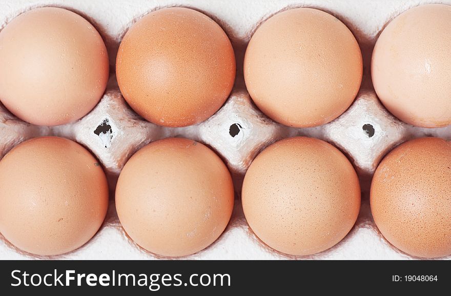 White eggs in carton. Nutritious eating.