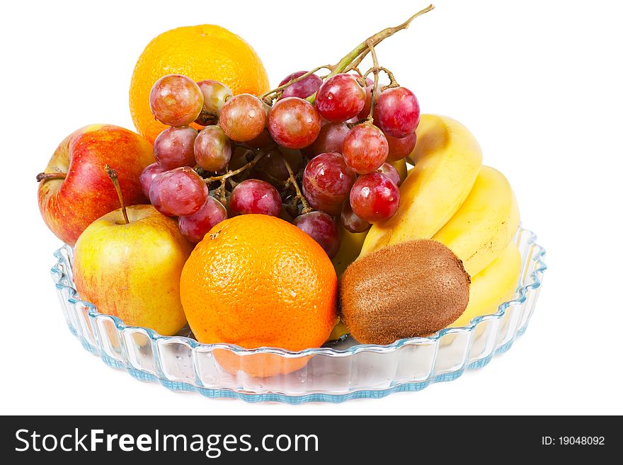 Fruits (apples, oranges, bananas, kiwi) on a plate