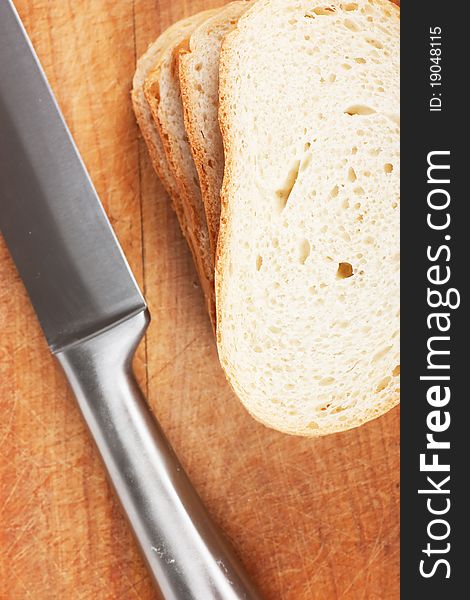 Knife and bread on a wood board