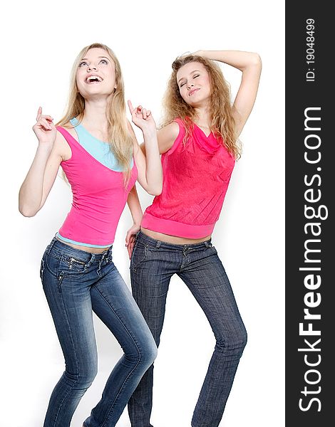 Two young women dancing over white