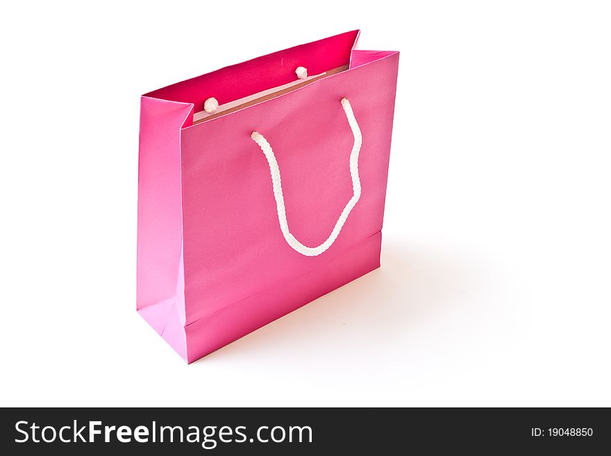 Pink shopping paper bag isolated on white background