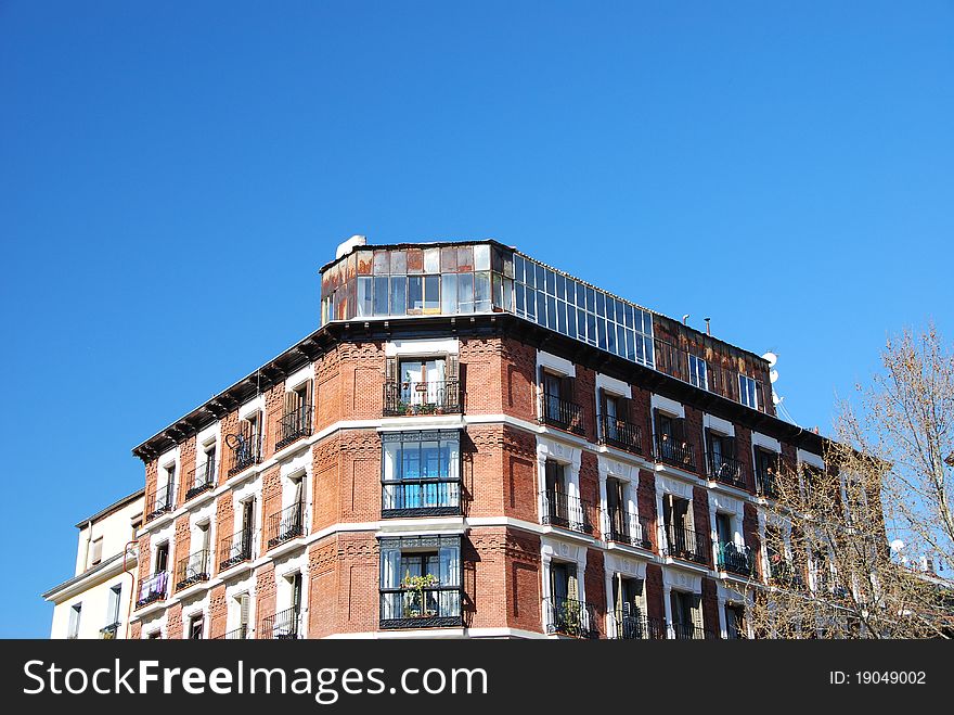 Front view of a building in the downtown of Madrid over a blue sky. Front view of a building in the downtown of Madrid over a blue sky