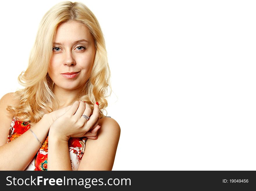 Attractive young woman smiles slyly on a white background