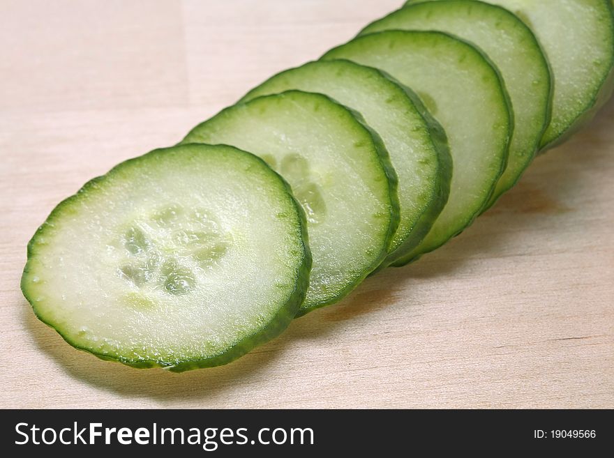 Fresh sliced â€‹â€‹cucumber on a wooden board