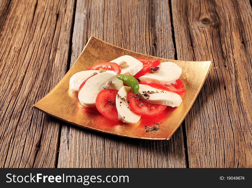 Slices of fresh tomato and mozzarella cheese. Slices of fresh tomato and mozzarella cheese