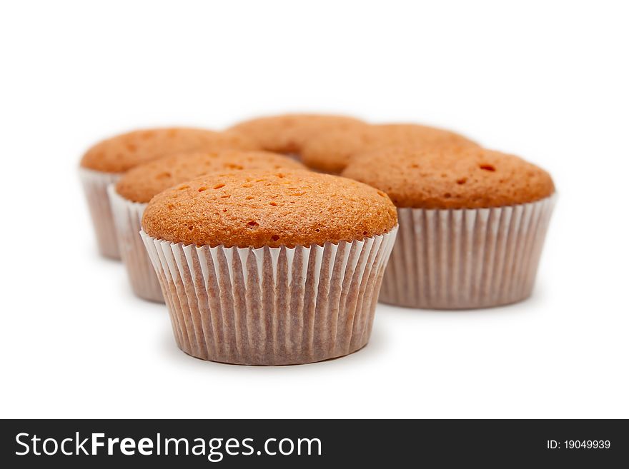 Sweet cakes in paper packing isolated on white