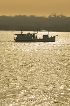 Fishing Boat Trawling At Sunset Royalty Free Stock Image