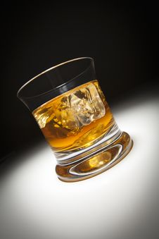 Glass Of Whiskey And Ice Under Spot Light. Stock Image Glass Of Whiskey And Ice Under Spot Light. Stock Image