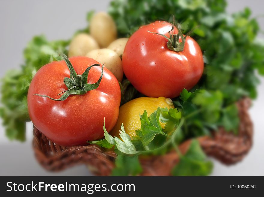 Tomatoes in a basket on a gray background-shallow dof