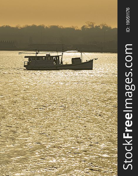 Fishing Boat Trawling At Sunset