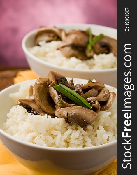 Photo of delicious risotto with mushrooms on wooden table