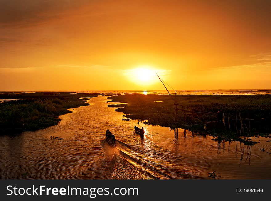 Sunrise and fisherman work in morning