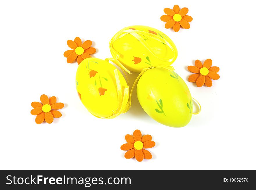Easter eggs and flowers on white background