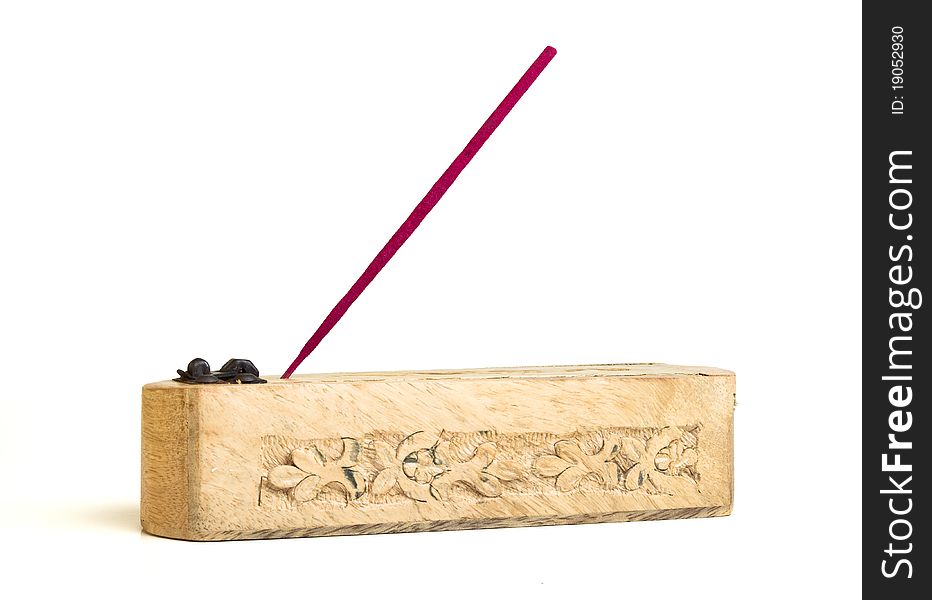 Carved wooden incense burner with joss stick isolated on white. Carved wooden incense burner with joss stick isolated on white.