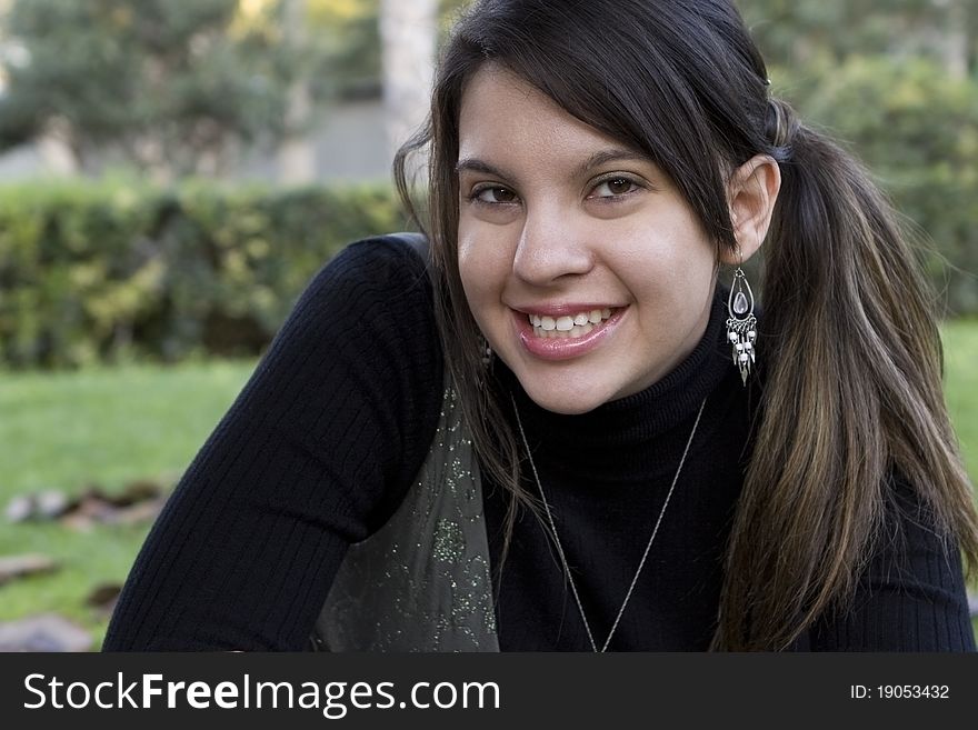 Beautiful Young Girl Smiling in a Park